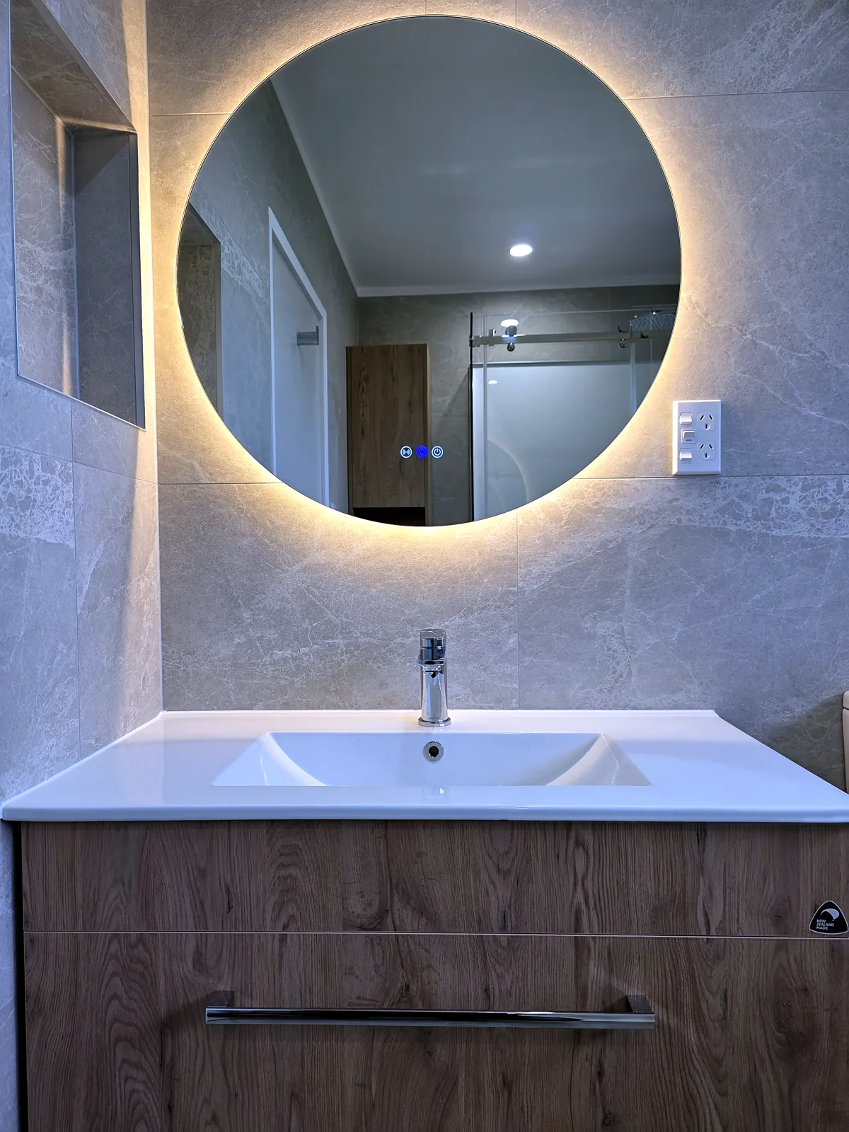 Bathroom vanity with backlit mirror