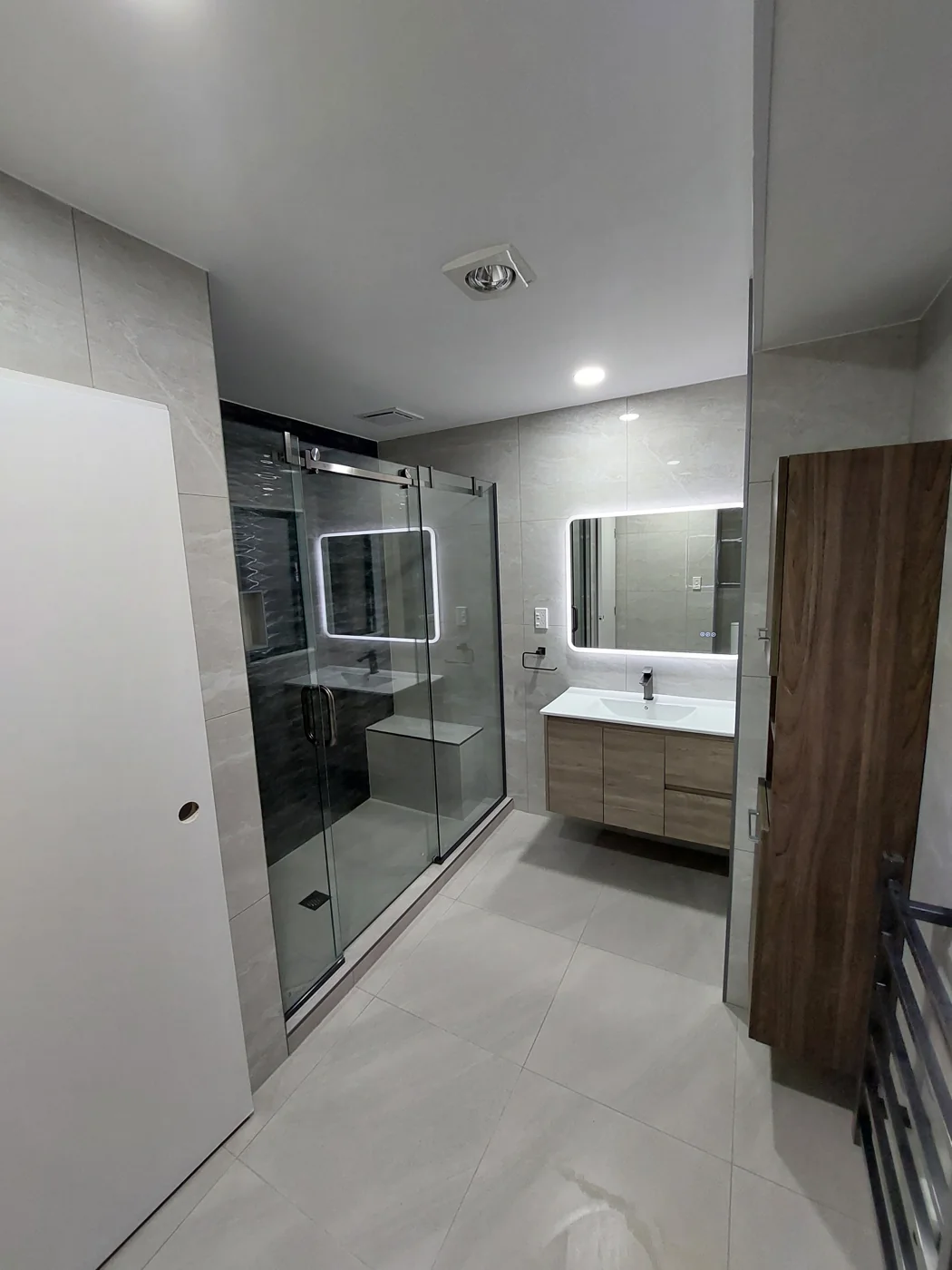 Modern bathroom with glass shower and timber vanity — Mount Wellington, Auckland